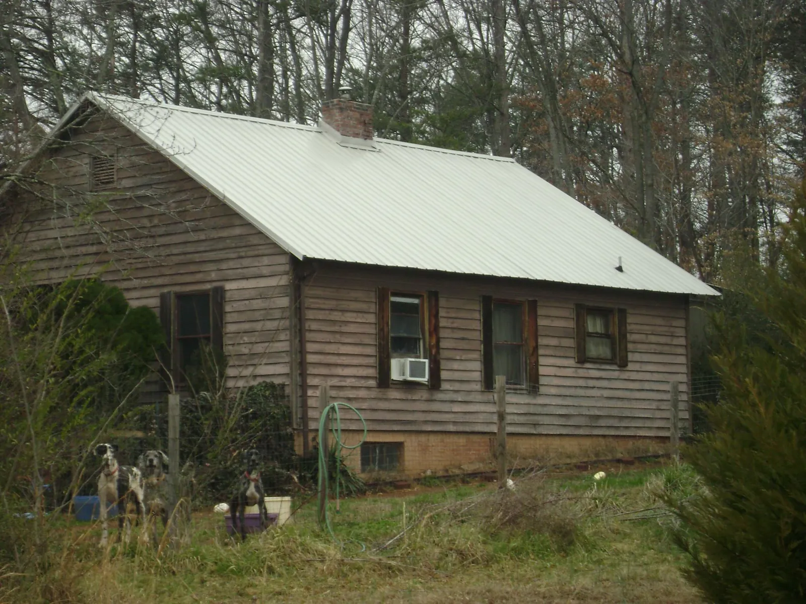 White metal roof on an old wood sided farmhouse, from a Metal Roof Installation job in Fallston